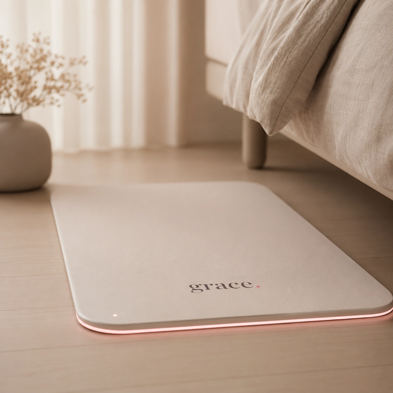 moss — soft grace floor mat with warm pink underglow beside a bed